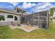 Screened-in pool and an outdoor lounge area with a fire pit creates a relaxing and fun atmosphere in backyard at 3142 Stonegate Falls Dr, Land O Lakes, FL 34638