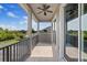 Second-story balcony with ceiling fan and expansive views, featuring sliding glass doors for seamless indoor-outdoor living at 3142 Stonegate Falls Dr, Land O Lakes, FL 34638