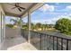 Balcony with a ceiling fan overlooking the pool area, surrounded by mature trees, offering great views at 3142 Stonegate Falls Dr, Land O Lakes, FL 34638