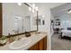 Bathroom featuring a double sink vanity and a view into the adjacent bedroom at 3142 Stonegate Falls Dr, Land O Lakes, FL 34638