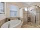 Bathroom featuring a modern glass enclosed shower and a large soaking tub with blinds at 3142 Stonegate Falls Dr, Land O Lakes, FL 34638