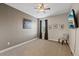 Spacious bedroom with a ceiling fan, mounted TV, and natural light at 3142 Stonegate Falls Dr, Land O Lakes, FL 34638