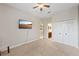 Bedroom with a ceiling fan, TV, and en-suite bathroom access at 3142 Stonegate Falls Dr, Land O Lakes, FL 34638