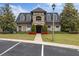 Luxurious clubhouse exterior with an elegant stone finish, manicured lawn, and convenient parking at 3142 Stonegate Falls Dr, Land O Lakes, FL 34638