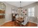 Cozy dining room with wood floors, a decorative chandelier, and modern decor at 3142 Stonegate Falls Dr, Land O Lakes, FL 34638