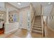 Bright foyer with staircase, front door, and view into dining area at 3142 Stonegate Falls Dr, Land O Lakes, FL 34638
