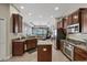 Spacious kitchen with an island, stainless steel appliances, and hardwood cabinets at 3142 Stonegate Falls Dr, Land O Lakes, FL 34638