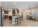 Well-lit kitchen with a breakfast bar, stainless steel appliances, and hardwood cabinets at 3142 Stonegate Falls Dr, Land O Lakes, FL 34638