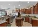 Open kitchen with stainless steel appliances, granite countertops, and hardwood cabinets at 3142 Stonegate Falls Dr, Land O Lakes, FL 34638