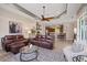 Open layout showcasing the living room with modern furnishings and a view into the kitchen at 3142 Stonegate Falls Dr, Land O Lakes, FL 34638
