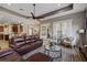 Spacious living room with ample seating, a glass coffee table, and plenty of natural light at 3142 Stonegate Falls Dr, Land O Lakes, FL 34638