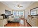 Main bedroom with large windows, hardwood floors, and tray ceiling at 3142 Stonegate Falls Dr, Land O Lakes, FL 34638