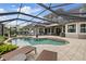 Inviting screened-in pool area with sun loungers, patio, and seamless access to the home's living spaces at 3142 Stonegate Falls Dr, Land O Lakes, FL 34638
