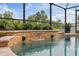 Close-up shot of in-ground pool with waterfall feature and lion head fountain elements at 3142 Stonegate Falls Dr, Land O Lakes, FL 34638