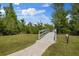 Picturesque paved walkway leading to a scenic pond offering an enjoyable outdoor experience for residents at 3142 Stonegate Falls Dr, Land O Lakes, FL 34638