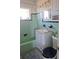 The bathroom features light-green tile, a white vanity with storage, and a shower-tub combination at 361 Fairhaven St, Port Charlotte, FL 33952