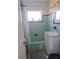 This bathroom features light-green tile, a white vanity and countertop, and a shower-tub combination at 361 Fairhaven St, Port Charlotte, FL 33952