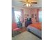Cozy bedroom with warm hardwood floors, a comfy bed, and a relaxing reading nook at 361 Fairhaven St, Port Charlotte, FL 33952