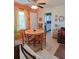 Bright and airy dining area with a view of the kitchen and living room at 361 Fairhaven St, Port Charlotte, FL 33952