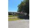 Street view of home with a mature shade tree in the front yard with green grass at 361 Fairhaven St, Port Charlotte, FL 33952