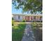 Charming single-story home with a well-manicured lawn and inviting walkway to the front door at 361 Fairhaven St, Port Charlotte, FL 33952