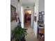 Bright hallway with tile flooring and walls decorated with numerous framed photos at 361 Fairhaven St, Port Charlotte, FL 33952