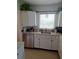 Well-lit kitchen featuring stainless steel appliances and white cabinetry at 361 Fairhaven St, Port Charlotte, FL 33952