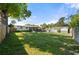 Expansive backyard with lush lawn, a screened-in porch, and a utility shed offer ample outdoor space at 3711 W Dale Ave, Tampa, FL 33609