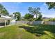 This serene backyard has a well-maintained lawn, a privacy fence, and a shed, providing a peaceful retreat at 3711 W Dale Ave, Tampa, FL 33609