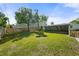 Spacious backyard features a lush lawn, mature trees, and a privacy fence, perfect for outdoor activities at 3711 W Dale Ave, Tampa, FL 33609