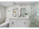 Beautiful bathroom featuring a glass-enclosed shower and a double sink vanity at 3711 W Dale Ave, Tampa, FL 33609