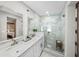 Modern bathroom featuring glass enclosed shower and double sink vanity at 3711 W Dale Ave, Tampa, FL 33609