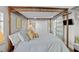 Spacious bedroom featuring a stylish canopy bed and sliding barn door at 3711 W Dale Ave, Tampa, FL 33609