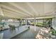 Spacious screened-in patio with seating and views of the lush backyard, perfect for enjoying the outdoors at 3711 W Dale Ave, Tampa, FL 33609