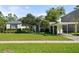 Landscaped front yard with a charming carport enhances this home's curb appeal and outdoor functionality at 3711 W Dale Ave, Tampa, FL 33609