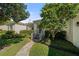 Charming home exterior with a manicured lawn, lush landscaping, and a welcoming walkway leading to the front door at 3711 W Dale Ave, Tampa, FL 33609