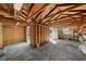 Unfinished garage interior with exposed rafters, concrete floor, work bench, and side storage at 3711 W Dale Ave, Tampa, FL 33609