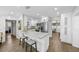Updated kitchen features white cabinets, stainless steel appliances, and breakfast bar, offering modern appeal at 3711 W Dale Ave, Tampa, FL 33609