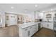 Open-concept kitchen with a breakfast bar, stainless steel appliances, and hardwood floors, perfect for gathering at 3711 W Dale Ave, Tampa, FL 33609