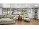 Bright living room features large windows, a comfortable sofa, and modern decor at 3711 W Dale Ave, Tampa, FL 33609