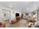 Cozy living room features hardwood floors, natural light, and an open layout, connecting seamlessly to the kitchen at 3711 W Dale Ave, Tampa, FL 33609