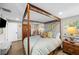 Comfortable main bedroom featuring a canopy bed, soft lighting, and neutral decor at 3711 W Dale Ave, Tampa, FL 33609