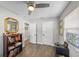 Home office featuring hardwood floors, a ceiling fan, and built-in bookcase at 3711 W Dale Ave, Tampa, FL 33609