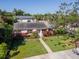 Charming single Gathering home featuring a well-manicured lawn and beautiful mature landscaping at 404 E Davis Blvd, Tampa, FL 33606