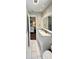 Beautiful bathroom with marble countertop, white cabinets, white flooring, and entry to the bedroom at 425 E Orange St, Tarpon Springs, FL 34689