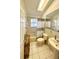 Well-lit bathroom features a tub and shower combination and decorative tiling at 425 E Orange St, Tarpon Springs, FL 34689