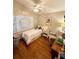 Comfortable bedroom with a ceiling fan and natural light from the windows at 425 E Orange St, Tarpon Springs, FL 34689