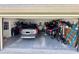 An open garage with gray floors containing a parked SUV and various items at 425 E Orange St, Tarpon Springs, FL 34689