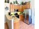 Well-lit kitchen with stainless steel appliances, wooden cabinets, tile floor, and a breakfast bar at 425 E Orange St, Tarpon Springs, FL 34689