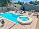 A beautiful swimming pool and spa are complemented by an outdoor seating area with a fire pit at 425 E Orange St, Tarpon Springs, FL 34689
